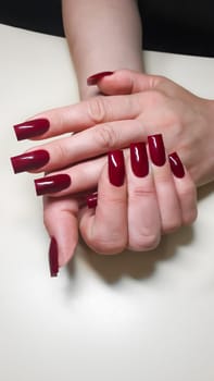 Acrylic nail extension, manicure, nail correction, hands in the foreground. Bright design. copy space