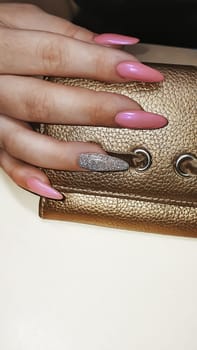 Acrylic nail extension, manicure, nail correction, hands in the foreground. Bright design. copy space