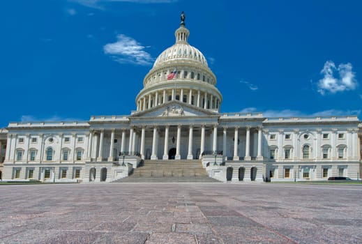 Washington DC Capitol detail on the deep blue cloudy sky