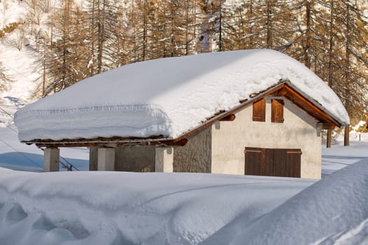 mountain house roofs covered by snow