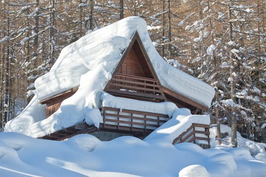 mountain house roofs covered by snow