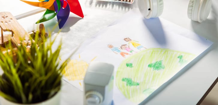 Child colorful drawing family standing hold hands on planet earth on white paper, Kid preschooler draw picture with pencil on table, Earth day concept