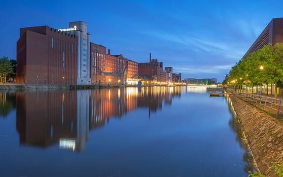 DUISBURG, GERMANY - AUGUST 12, 2023: Panoramic image of historical city harbor of Duisburg during evening light on August 12, 2023 in Germany