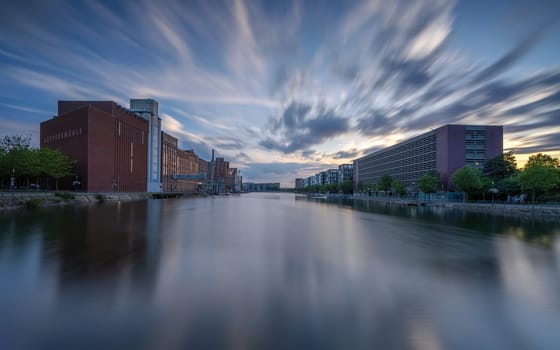 DUISBURG, GERMANY - AUGUST 12, 2023: Panoramic image of historical city harbor of Duisburg during evening light on August 12, 2023 in Germany