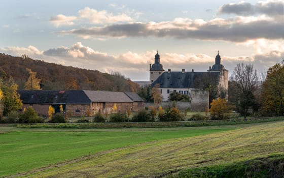MECHERNICH, GERMANY - NOVEMBER 19, 2023: Panoramic image of old Veynau castle during evening on November 19, 2023 in Eifel, North Rhine Westphalia, Germany