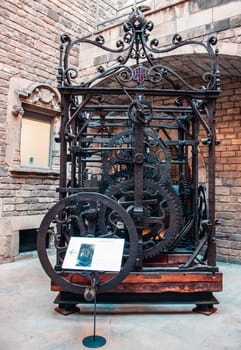 View of the mechanism of the turret clock in museum. Clockwork mechanism of church clock tower photo. Barcelona, street scene. High quality picture for wallpaper, article