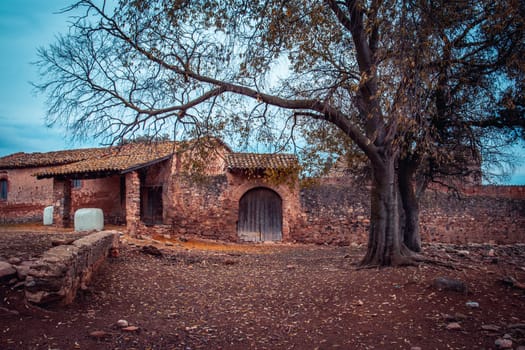 Farming house in the countryside of a small village in Catalonia. Typical country house or farmhouse in Spain. Red old brick wall texture background. High quality picture for wallpaper, article