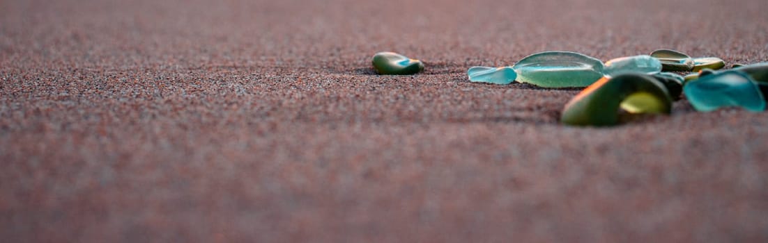 Mediterranean sea beach and colorful stones photo. Glass stones from broken bottles polished by the sea. Front view photography with blurred background. High quality picture for wallpaper, travel blog