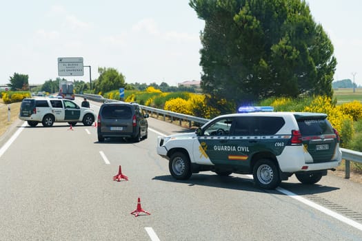 Sahagun, Spain - June 5, 2023: Civilian police are restricting traffic and blocking traffic with police vehicles.