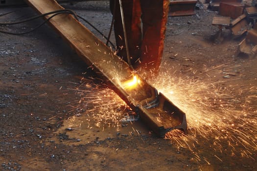 Cutting an old metal rail with a gas burner flame, close-up. Autogen operation.