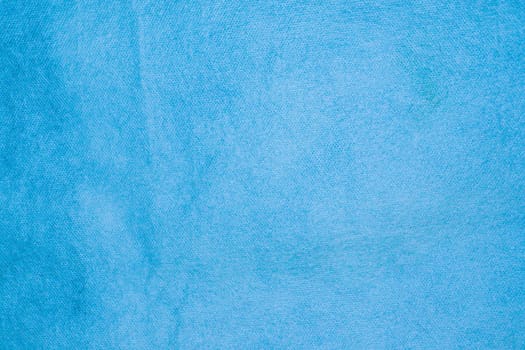 Spongebond texture in blue. Blue nonwoven polypropylene material texture background.