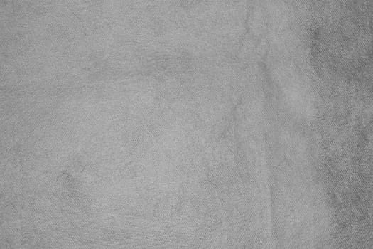Texture of non-woven material in gray. Background for copy spaced designs.
