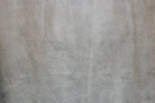 Abstract Spunchbond gray background. Texture for a design made of old outdated artificial gray fabric.