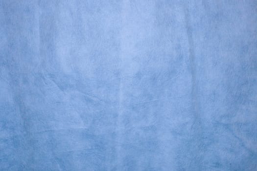 Spongebond texture in blue. Blue nonwoven polypropylene material texture background.