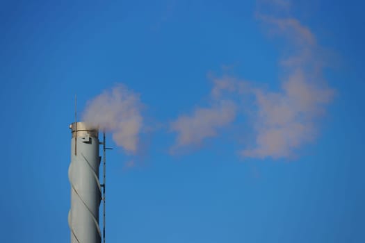 Rusty chimney. A metal pipe with white smoke coming from it...Ecological concept. Carbon Emissions Concept. Ecological concept...