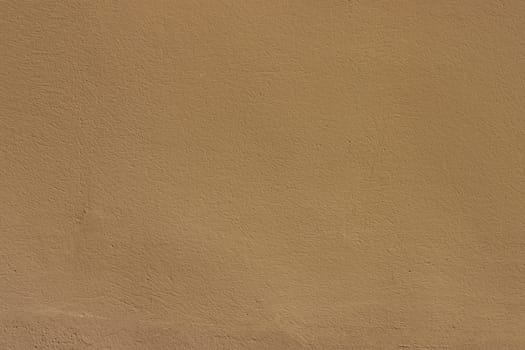 Old wall painted with brown paint. Texture of time-damaged paint. .Texture for design with copy space.