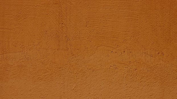 Close-up surface of an old wall in light orange color. .Texture for design with copy space.