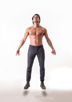 A man with no shirt standing in the air
