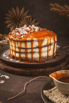 Delicious caramel cake with small pieces of pecan nuts and coconut shavings.