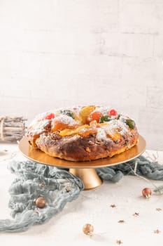 Bolo do Rei or King's Cake, Made for Christmas, Carnavale or Mardi Gras with Christmas season elements in Background.