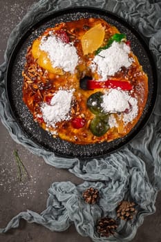 Bolo Rei or Kings Cake is a traditional Xmas cake with fruits raisins nut and icing on kitcthen countertop. Is made for Christmas, Carnavale or Mardi Gras