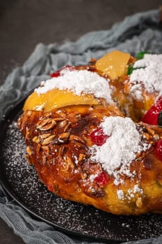 Bolo Rei or Kings Cake is a traditional Xmas cake with fruits raisins nut and icing on kitcthen countertop. Is made for Christmas, Carnavale or Mardi Gras