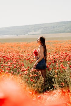 Woman poppies field. portrait of a happy woman with long hair in a poppy field and enjoying the beauty of nature in a warm summer day