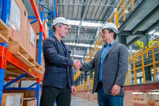Professional business man or engineer shake hands for success of the project in factory industrial workplace or train factory.