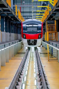 Vertical image of front electrical or metro train in the factory workplace with no people during wait to check and maintenance from professional team.
