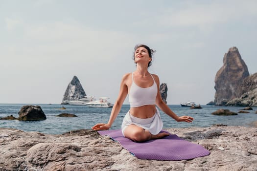 Fitness woman sea. Outdoor workout on yoga mat in park near to ocean beach. Female fitness pilates yoga routine concept. Healthy lifestyle. Happy fit woman exercising with rubber band in park.