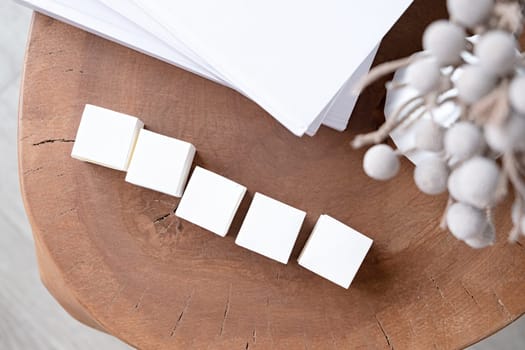 five blank white block cubes for writing a word on wooden table , Business communication concept