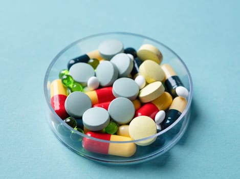 composition with pill box and pills on blue color background