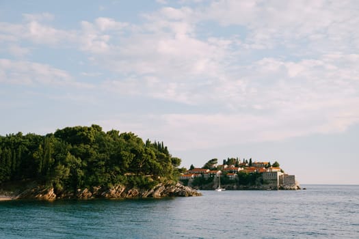 Island of Sveti Stefan protrudes from the rocky shore. Montenegro. High quality photo