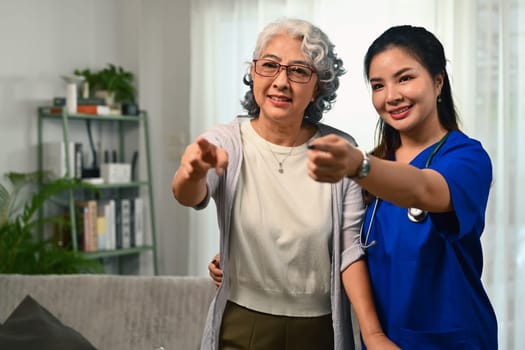 Caring healthcare worker talking while visiting senior woman patient at home. Healthcare concept