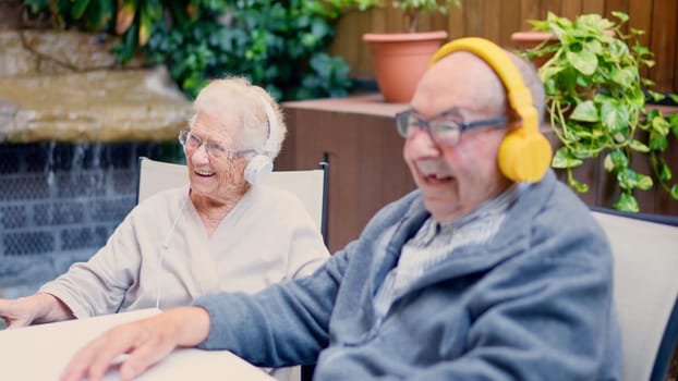 Video of a senior couple listening to music on the garden of geriatric