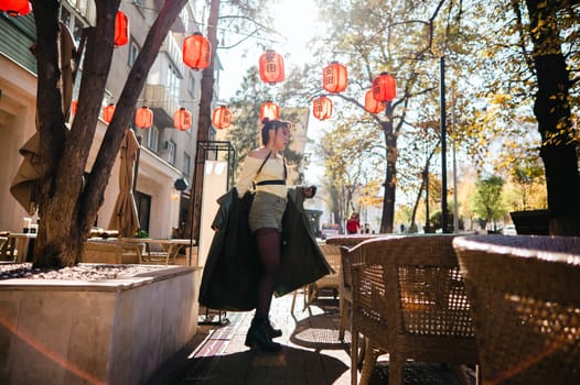 Full length portrait of Asian woman in front of Chinese lanterns