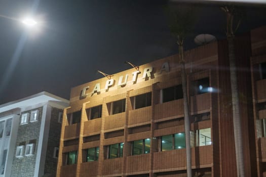 Jakarta, Indonesia - October 4 2023: Nighttime Illuminated Office Building Sign