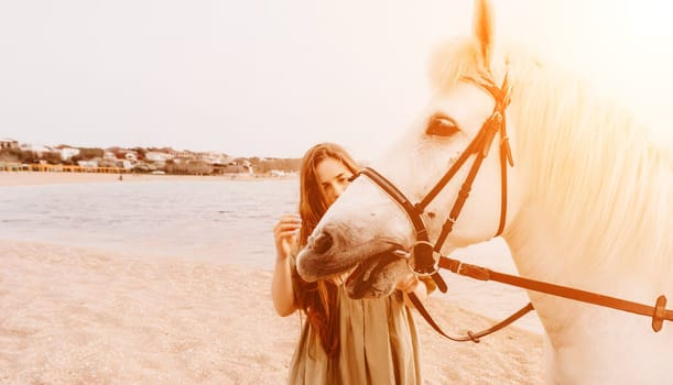 A white horse and a woman in a dress stand on a beach, with the sky and sea creating a picturesque backdrop for the scene