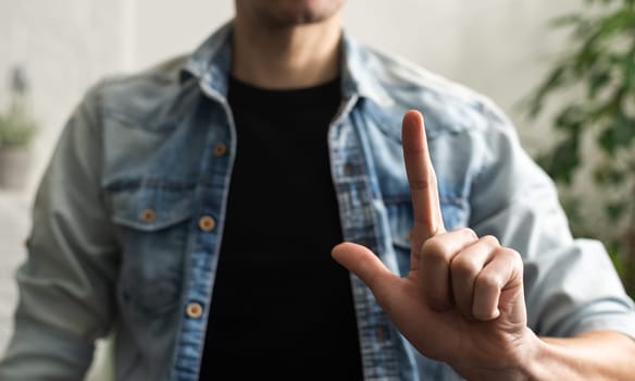 Man showing gesture in sign language on white background.