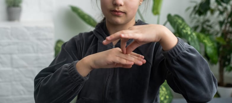 Beautiful smiling deaf girl using sign language