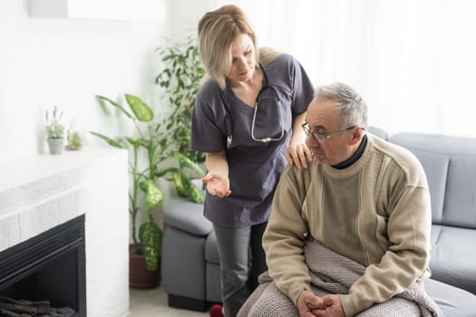 doctor talking to her male senior patient at office