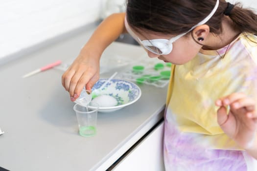 Children are learning and doing science experiments. Little girl playing science experiment for home schooling. Easy and fun science experiments for kids at home