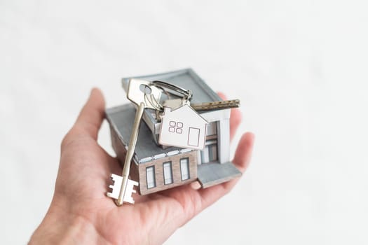 Small toy house in hands