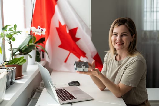 Young female student with Canadian flag and laptop with space for text. High quality photo