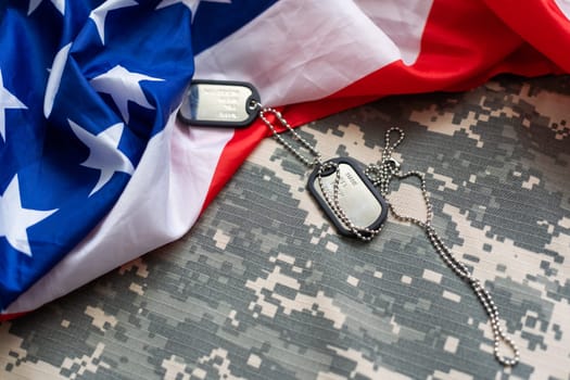 Army tokens on military uniform and USA national flag background