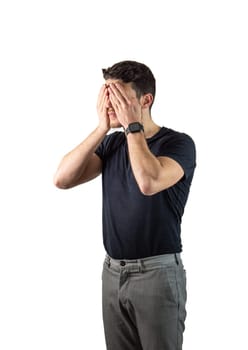 Attractive young man covering eyes with his hands in studio shot. Secret concept. Isolated on white