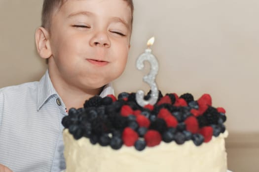 A boy blows out the candles for his birthday