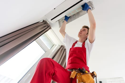 technician service removing air filter of the air conditioner for cleaning