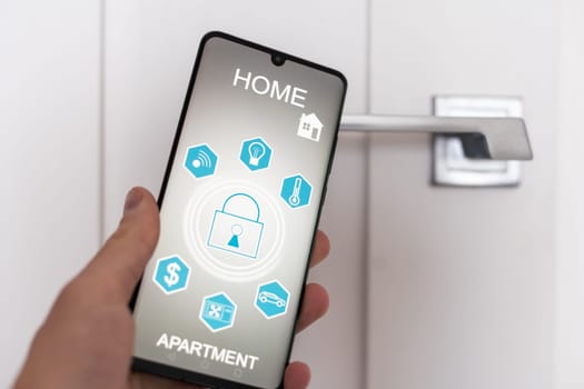 Locking smartlock on the entrance door using a smart phone remotely. Concept of using smart electronic locks with keyless access. High quality photo