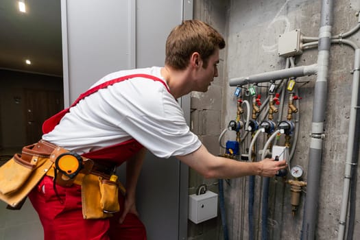 maintenance - technician checking pressure meters for house heating system